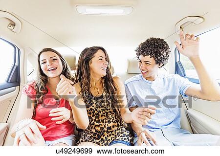 Stock Photo - Young people and teenager (14-15) having fun in car. Fotosearch