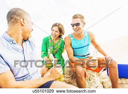 Young people drinking beer on beach View Large Photo Image Stock Photo - Young people drinking beer on beach. Fotosearch