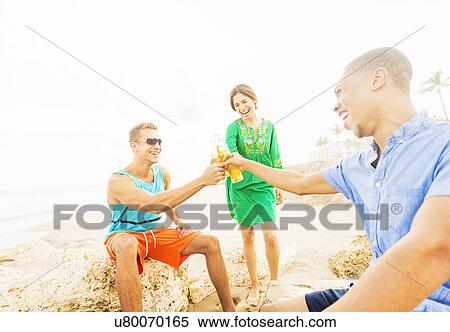 Young people drinking beer on beach View Large Photo Image Stock Photography - Young people drinking beer on beach. Fotosearch