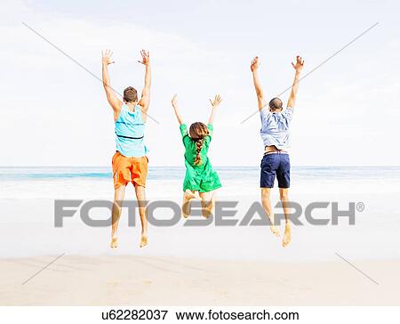 Young people jumping on beach View Large Photo Image Stock Photo - Young people jumping on beach. Fotosearch