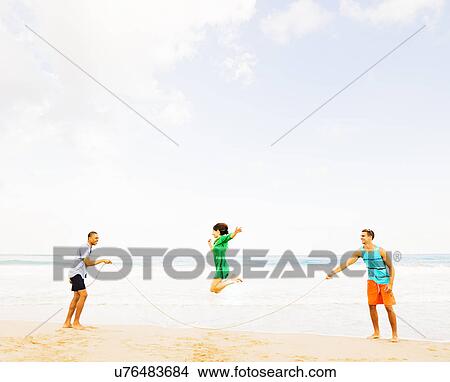 Young people playing on beach View Large Photo Image Picture - Young people playing on beach. Fotosearch