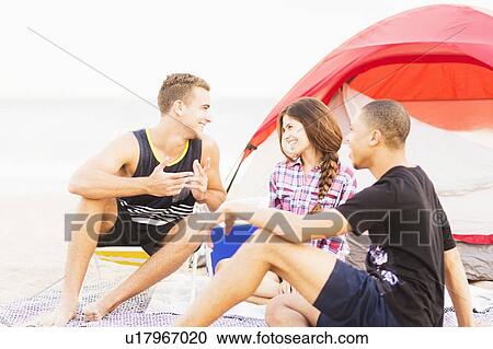 Young people relaxing on beach View Large Photo Image Stock Image - Young people relaxing on beach. Fotosearch