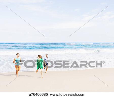 Young people running on beach View Large Photo Image Stock Photography - Young people running on beach. Fotosearch