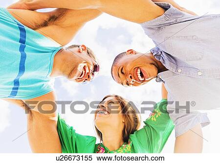 Stock Photography - Young people with arms around each other. Fotosearch