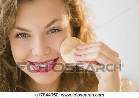 Young woman applying make up foundation View Large Photo Image Stock Image - Young woman applying make up foundation. Fotosearch