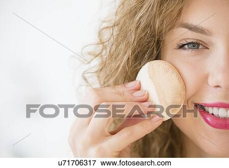 Young woman applying make up foundation View Large Photo Image Stock Photo - Young woman applying make up foundation. Fotosearch