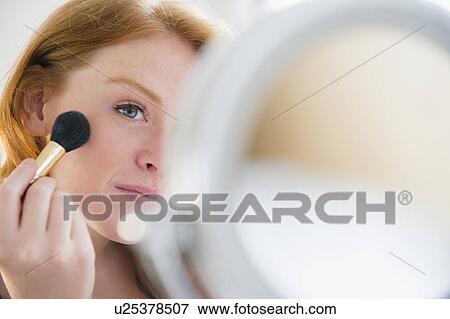 Young woman applying make up View Large Photo Image Stock Photo - Young woman applying make up. Fotosearch