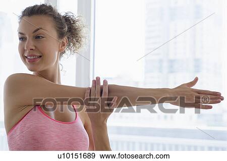 Stock Photo - Young woman doing stretching. Fotosearch