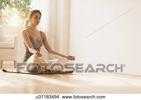 Picture - Young woman practicing yoga . Fotosearch