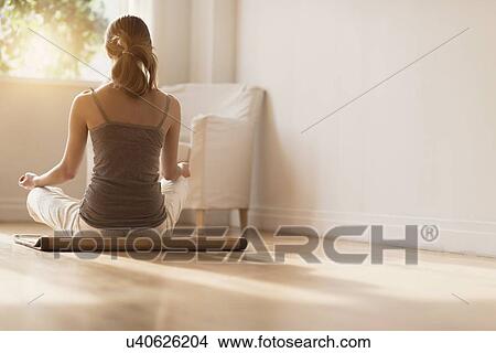 Young woman practicing yoga View Large Photo Image Picture - Young woman practicing yoga . Fotosearch