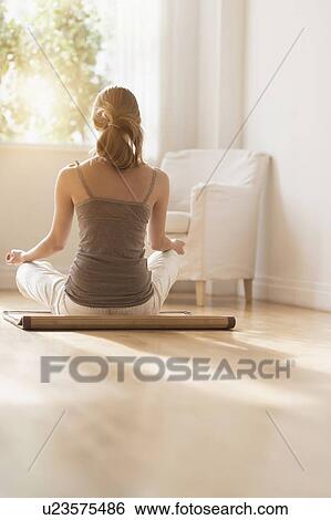 Young woman practicing yoga View Large Photo Image Stock Photograph - Young woman practicing yoga . Fotosearch