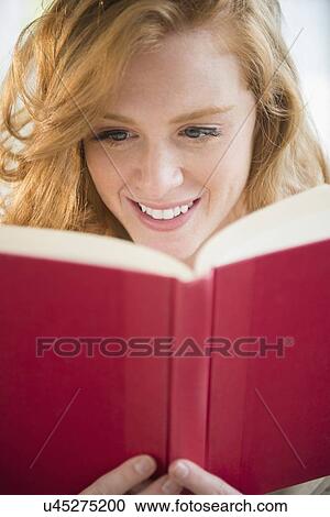 Young woman reading book View Large Photo Image Stock Image - Young woman reading book. Fotosearch