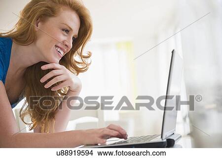 Young woman using laptop View Large Photo Image Picture - Young woman using laptop. Fotosearch