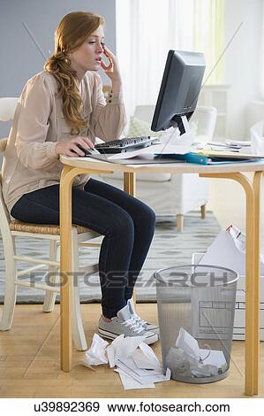 Stock Photo - Young woman working at home. Fotosearch