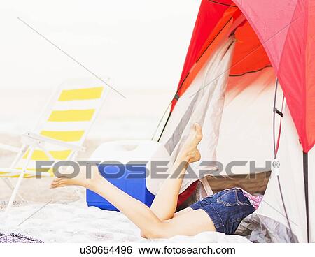 Young woman's legs sticking out from tent View Large Photo Image Stock Photograph - Young woman's legs sticking out from tent. Fotosearch
