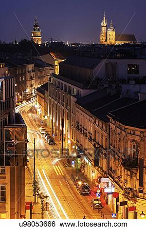 Stock Photograph - Zwierzyniecka Street and Town Hall with St Mary's Church in background. Fotosearch