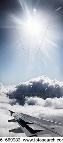 Airplane wing flying over clouds View Large Photo Image Stock Image - Airplane wing flying over clouds. Fotosearch
