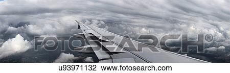 Airplane wing flying over clouds View Large Photo Image Stock Image - Airplane wing flying over clouds. Fotosearch