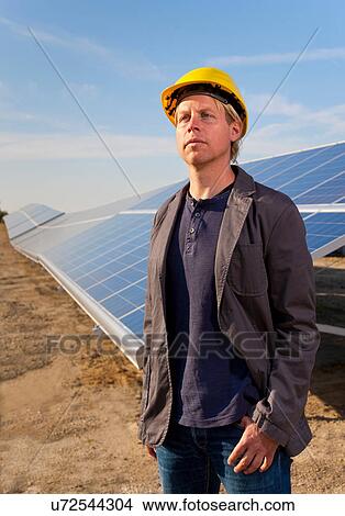 Architect in field with solar panels View Large Photo Image Picture - Architect in field with solar panels. Fotosearch