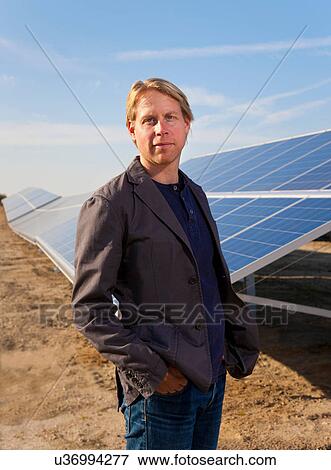 Architect in field with solar panels View Large Photo Image Stock Photo - Architect in field with solar panels. Fotosearch
