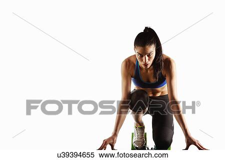 Stock Photography - Athlete crouched at starting block. Fotosearch