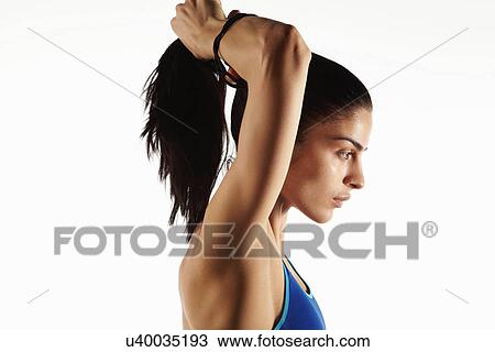 Athlete putting up her hair View Large Photo Image Stock Image - Athlete putting up her hair. Fotosearch
