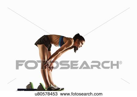 Stock Image - Athlete resting at starting block. Fotosearch