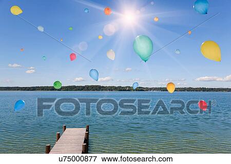 Balloons floating over still lake View Large Photo Image Stock Photo - Balloons floating over still lake. Fotosearch
