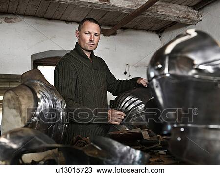 Blacksmith crafting armor in shop View Large Photo Image Stock Image - Blacksmith crafting armor in shop. Fotosearch