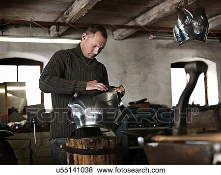 Blacksmith crafting armor in shop View Large Photo Image Stock Photo - Blacksmith crafting armor in shop. Fotosearch