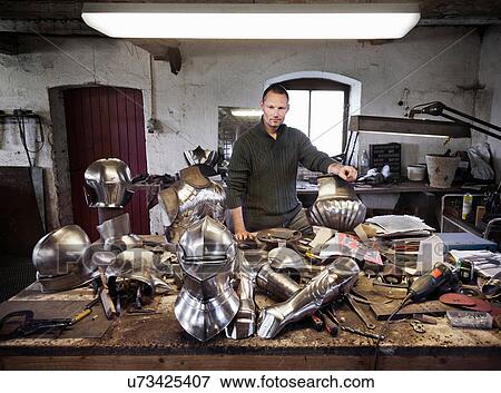 Stock Photo - Blacksmith with armor in shop. Fotosearch