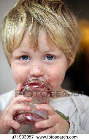 Boy eating jam from jar View Large Photo Image Stock Photo - Boy eating jam from jar. Fotosearch