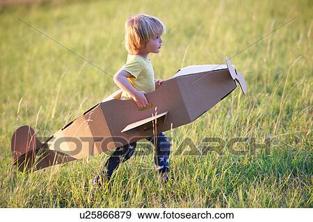 Boy flying airplane outdoors View Large Photo Image Stock Photo - Boy flying airplane outdoors. Fotosearch