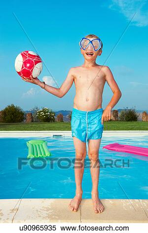Stock Photography - Boy in mask playing by swimming pool. Fotosearch