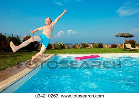 Boy jumping into swimming pool View Large Photo Image Stock Image - Boy jumping into swimming pool. Fotosearch