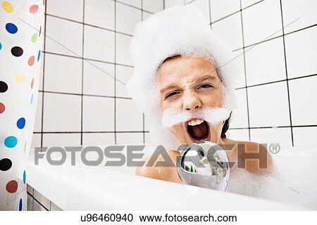 Boy playing in bubble bath View Large Photo Image Stock Image - Boy playing in bubble bath. Fotosearch
