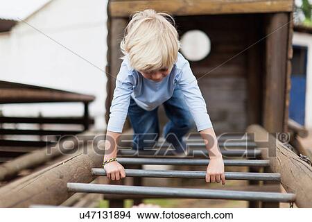 Boy playing on monkey bars View Large Photo Image Picture - Boy playing on monkey bars. Fotosearch