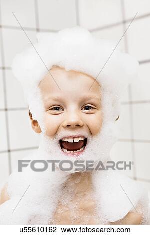 Boy playing with bubbles in bath View Large Photo Image Stock Image - Boy playing with bubbles in bath. Fotosearch