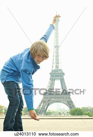 Stock Image - Boy posing with Eiffel Tower in Paris. Fotosearch