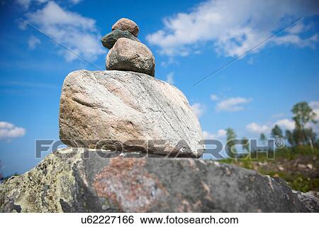 Boy stacking rocks outdoors View Large Photo Image Stock Photograph - Boy stacking rocks outdoors. Fotosearch