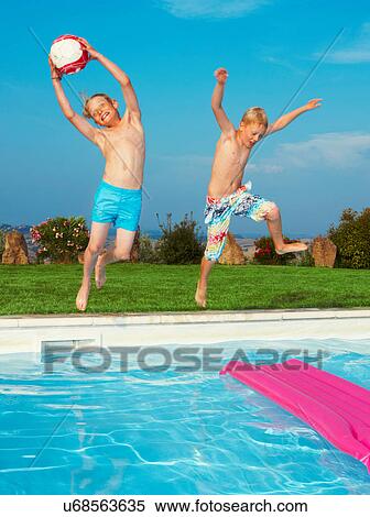 Boys jumping into swimming pool View Large Photo Image Stock Photography - Boys jumping into swimming pool. Fotosearch