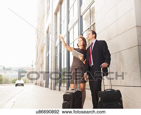 Stock Image - Business people admiring city street. Fotosearch