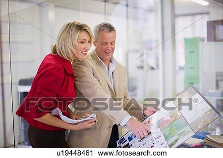 Business people examining project View Large Photo Image Stock Image - Business people examining project. Fotosearch