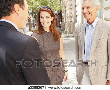 Business people shaking hands outdoors View Large Photo Image Stock Image - Business people shaking hands outdoors. Fotosearch