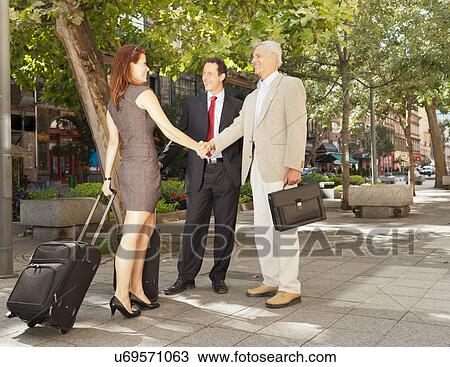 Business people shaking hands outdoors View Large Photo Image Stock Image - Business people shaking hands outdoors. Fotosearch