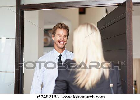 Business people smiling at each other View Large Photo Image Stock Image - Business people smiling at each other. Fotosearch
