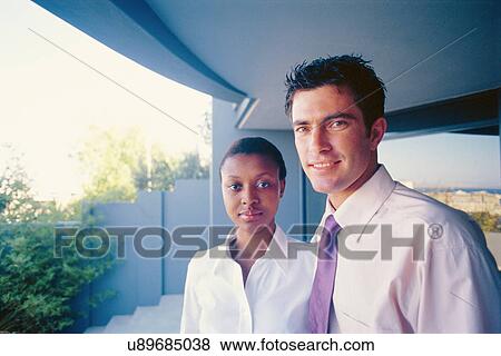 Business people smiling in courtyard View Large Photo Image Stock Photo - Business people smiling in courtyard. Fotosearch