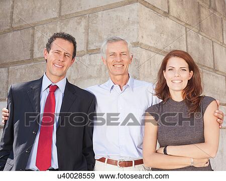 Business people standing together View Large Photo Image Stock Photo - Business people standing together. Fotosearch