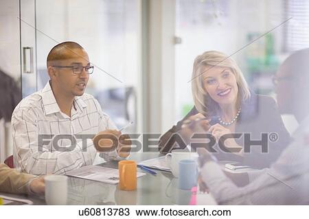 Stock Image - Business people talking in meeting. Fotosearch