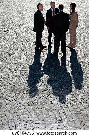 Business people talking on cobbled road View Large Photo Image Stock Photography - Business people talking on cobbled road. Fotosearch
